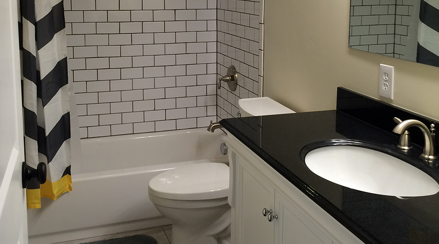 small-bathroom-with-black-sink-counter-and-subway-tiles-tooele-ut